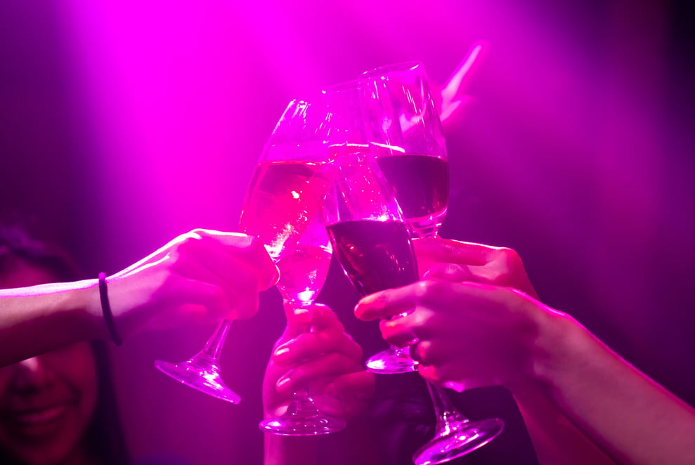 Group of people toast drinks at party in dancing club